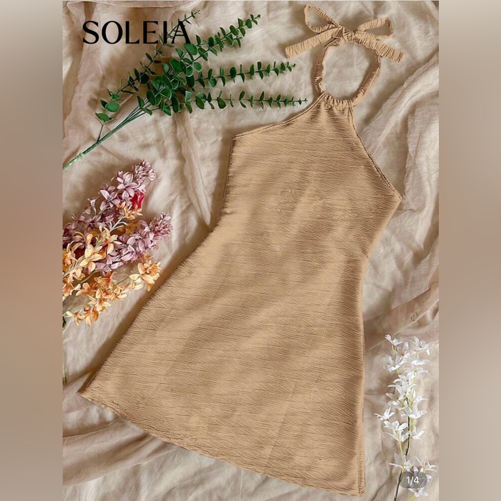 Beige halter backless beach dress. Wavy pattern.
